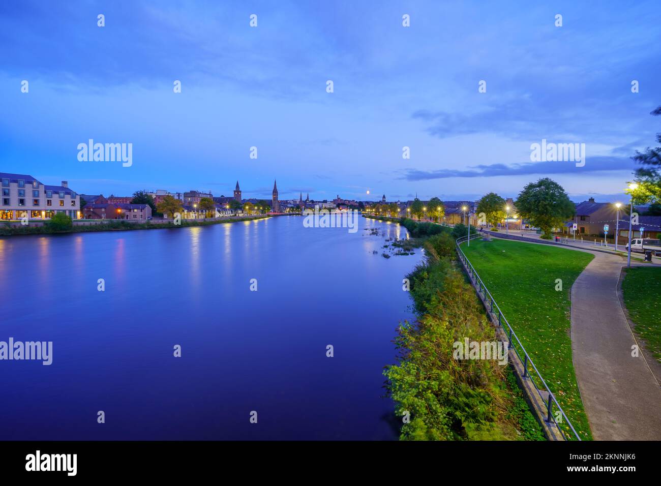 Evening view of the River Ness and Inverness skyline, with the moon. Scotland, UK Stock Photo
