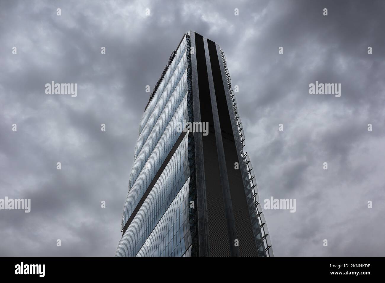 Milan, Italy - June 26, 2022: Bottom View of Allianz Tower in Tre Torri. Look Up at CityLife Financial Architectural Building with Cloudy Sky. Stock Photo