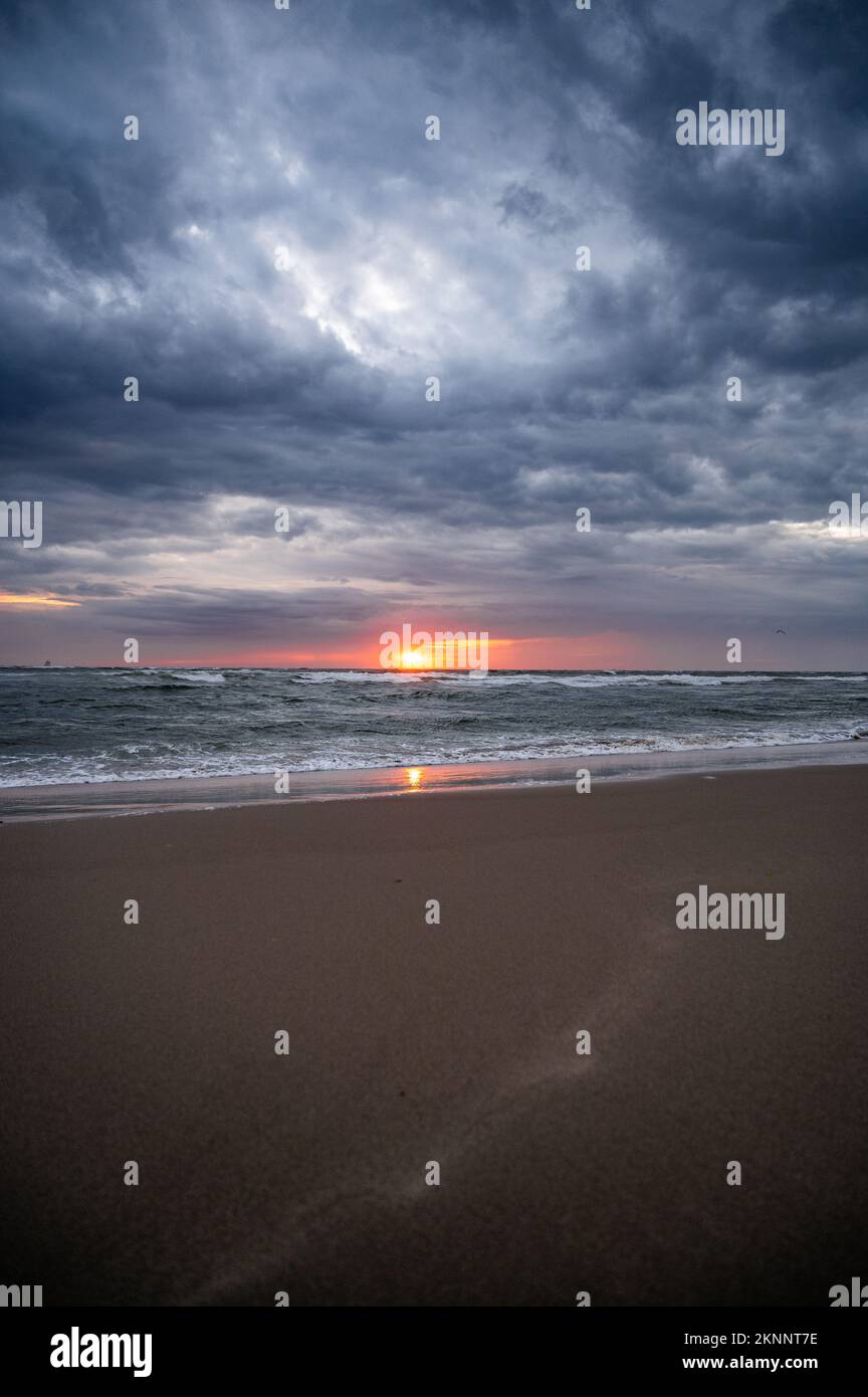 A breathtaking view of the sunset over a stormy sea Stock Photo - Alamy