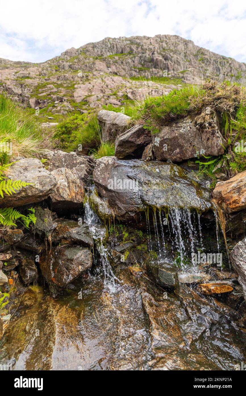 A vertical shot of a waterfall flowing down the rocks Stock Photo - Alamy