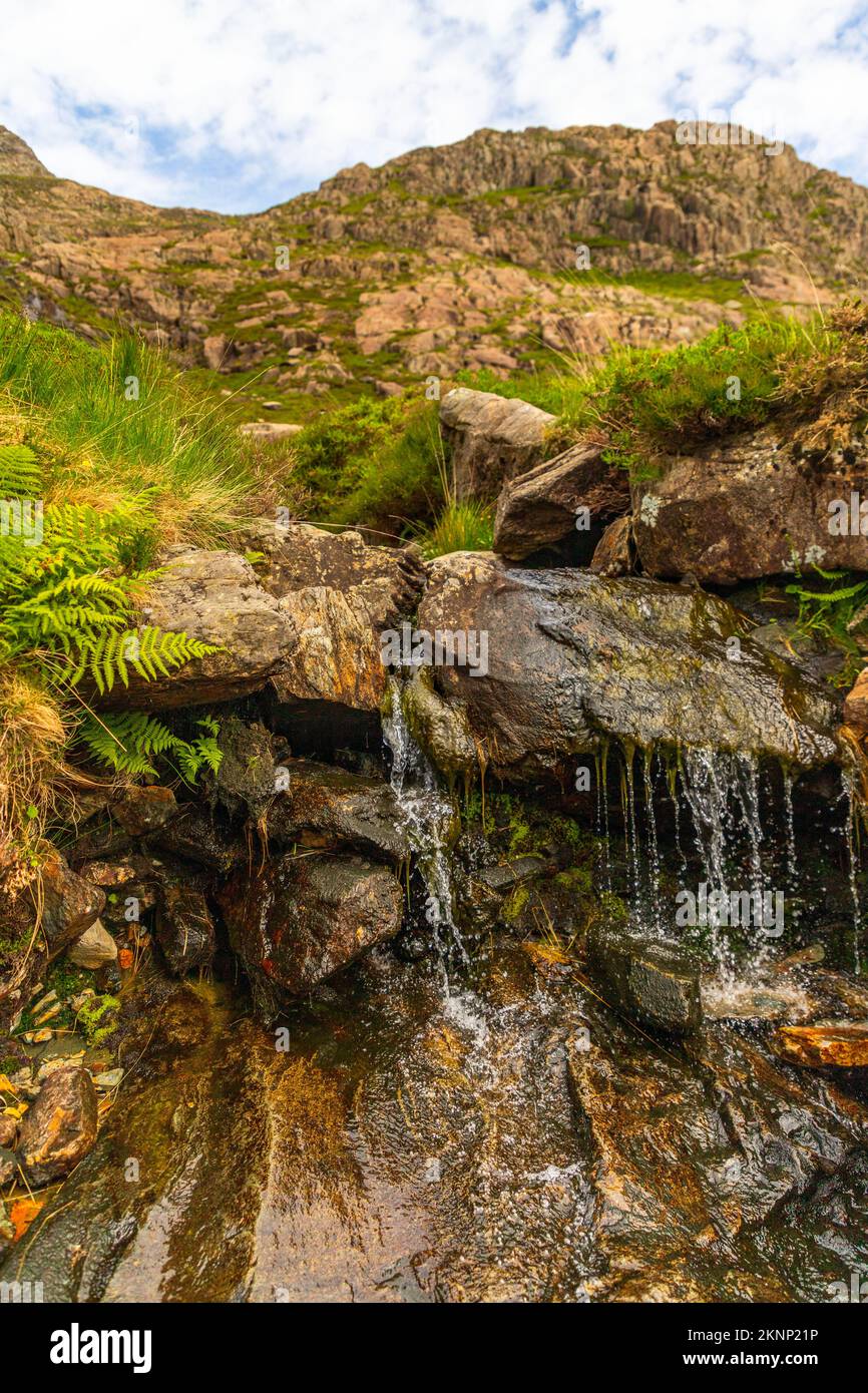 A vertical shot of a waterfall flowing down the rocks Stock Photo - Alamy