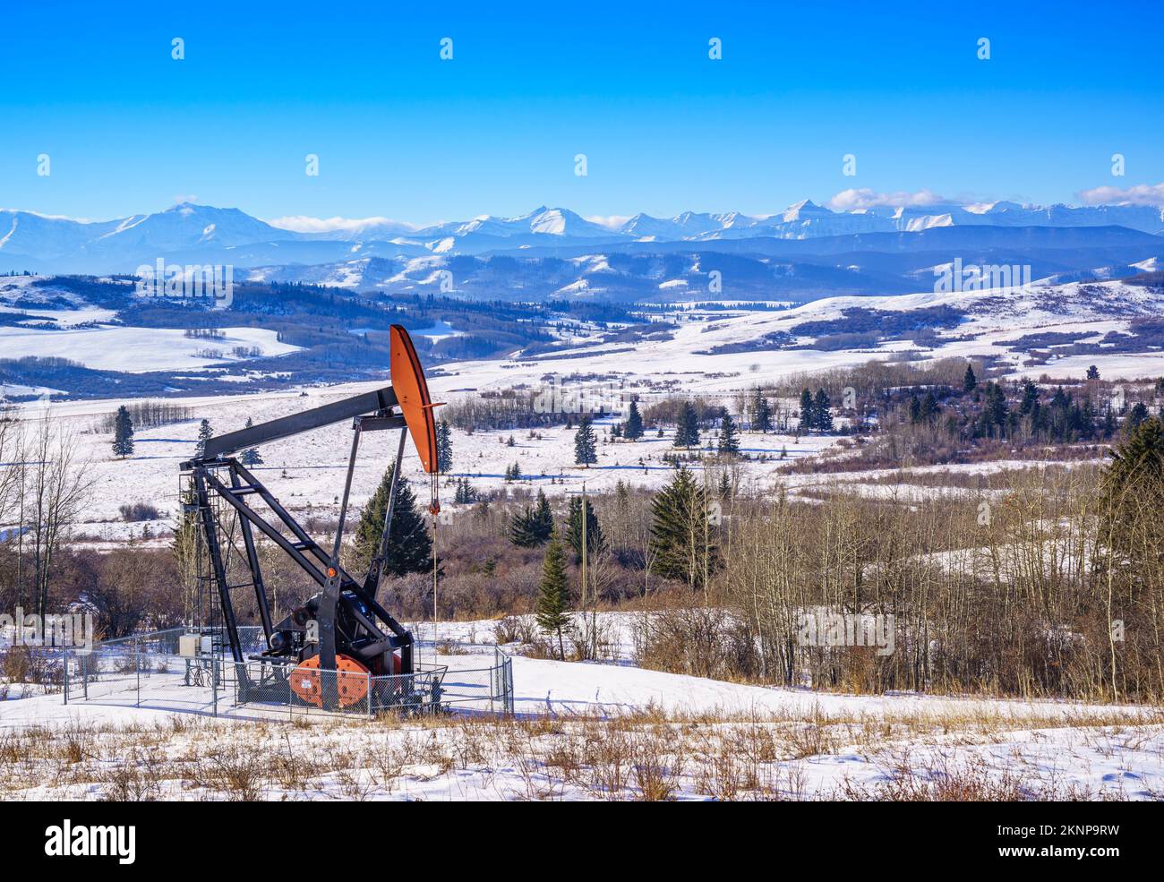 A pump jack on an oil well in the Alberta foothills Stock Photo Alamy