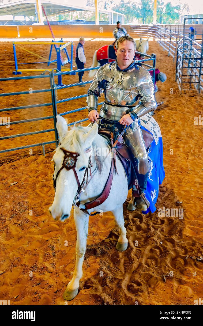 A jouster in silver armor rides his horse out of the ring during the annual Celtic Music Festival and Scottish Highland Games in Gulfport, Mississippi. Stock Photo