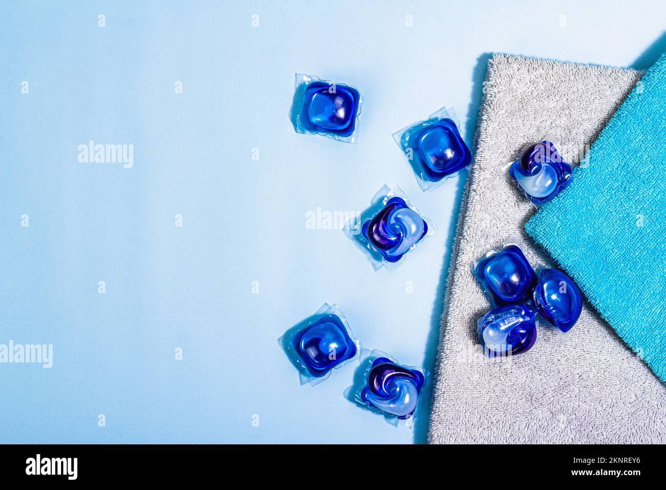 Machine washing concept. Capsules with detergent, soft towels, winter