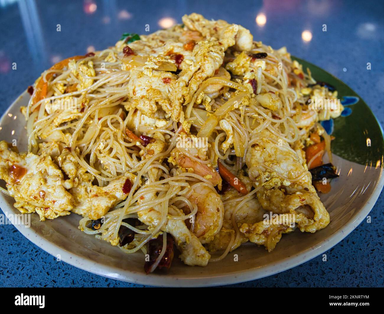 Singapore style noodles a dish of stirfried cooked rice noodles Stock