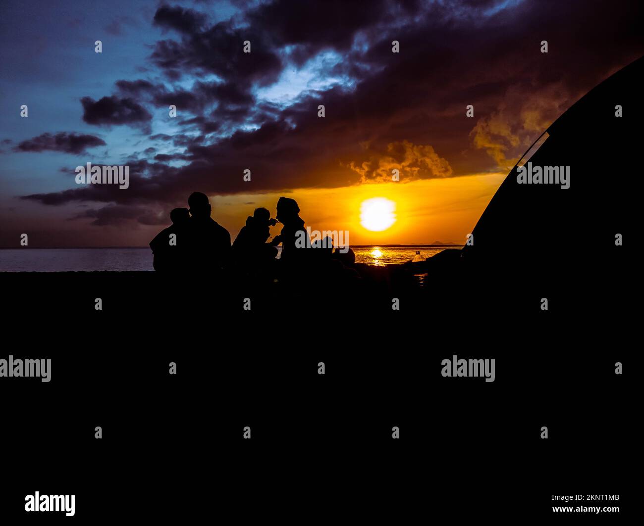 silhouette of people with sunrise on the beach Stock Photo