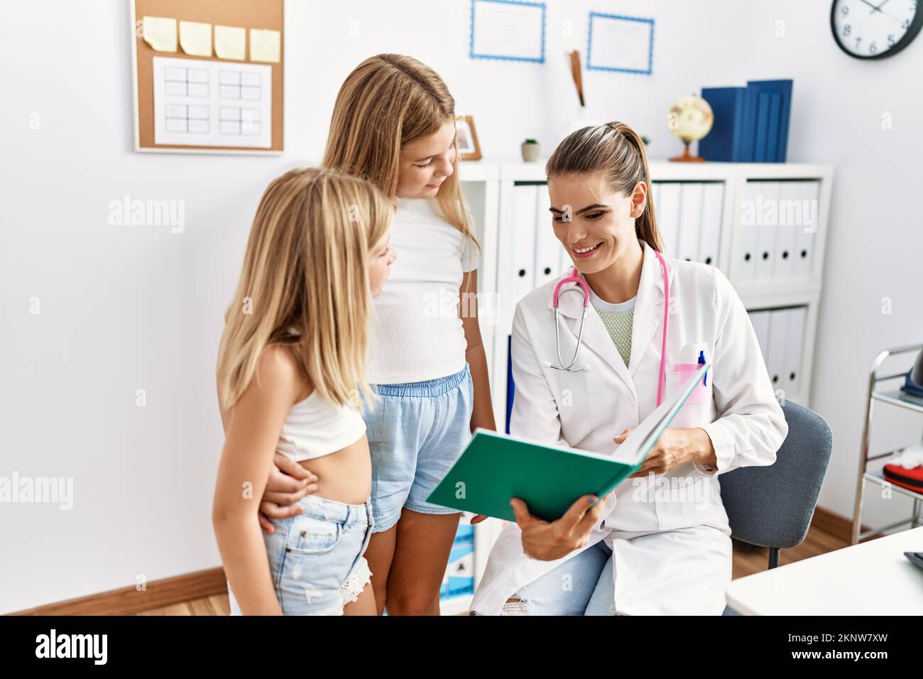 Mother and daughters doctor and patient looking book having medical ...