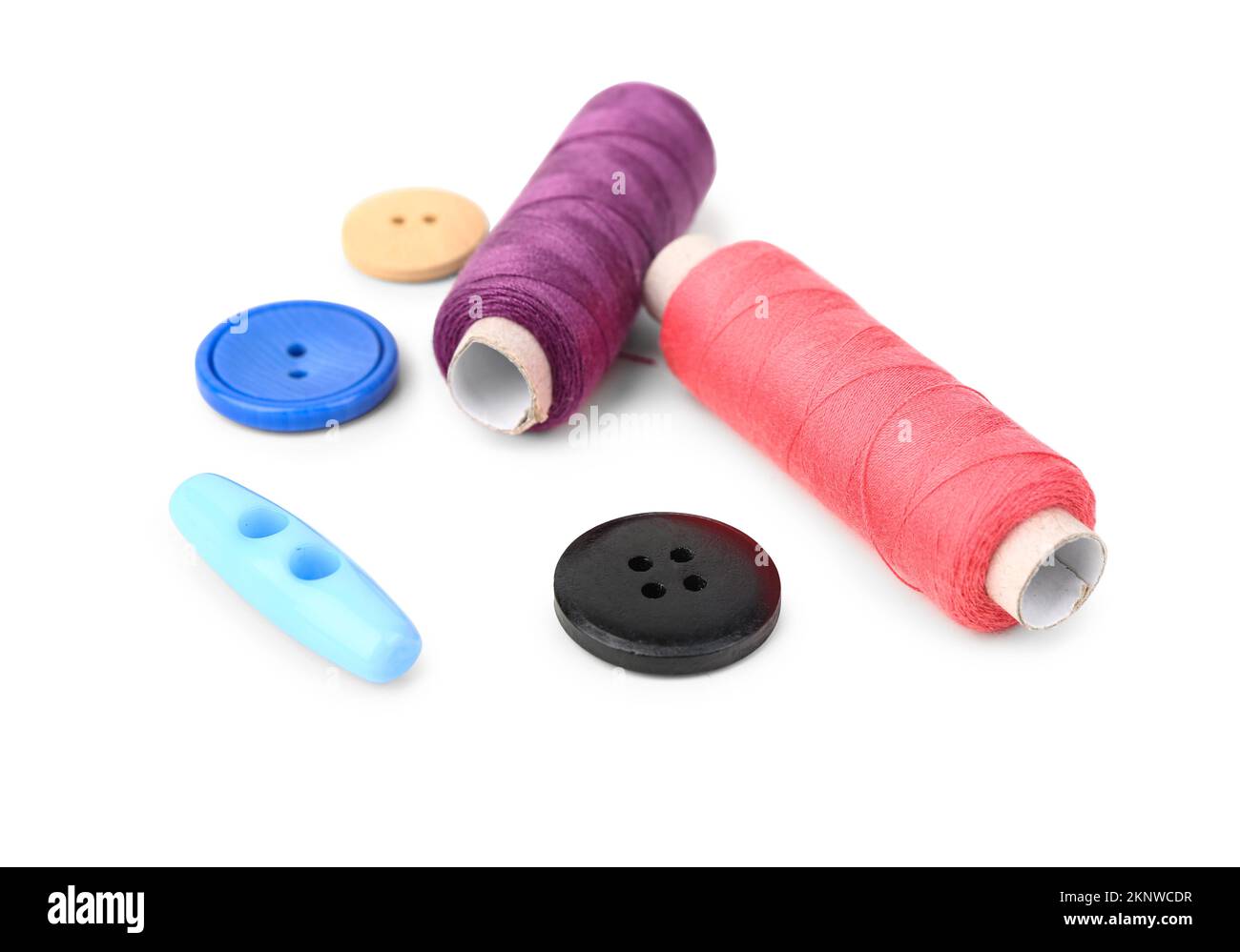 Colorful thread spools and buttons on white background Stock Photo - Alamy