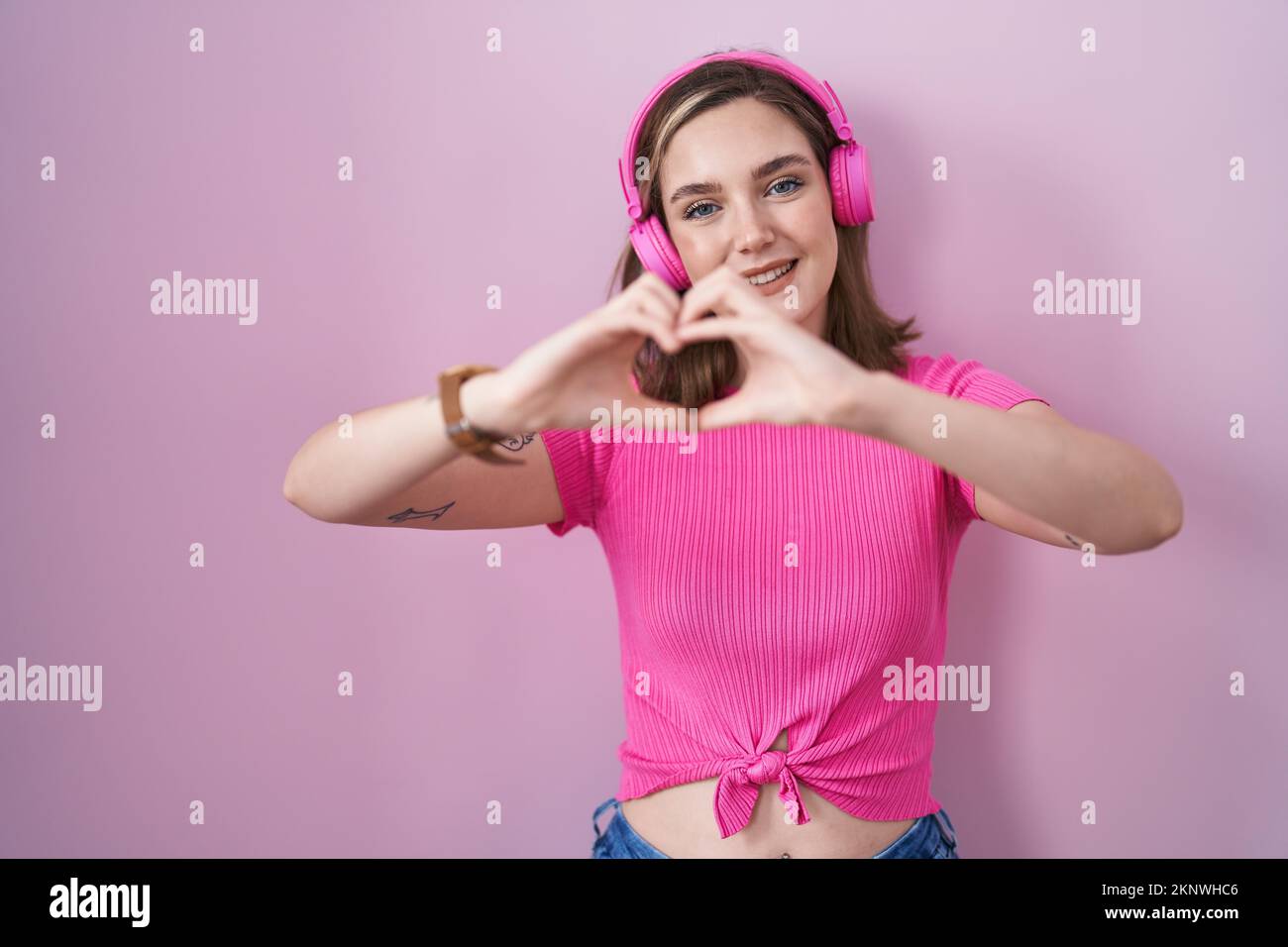 Blonde caucasian woman listening to music using headphones smiling in ...