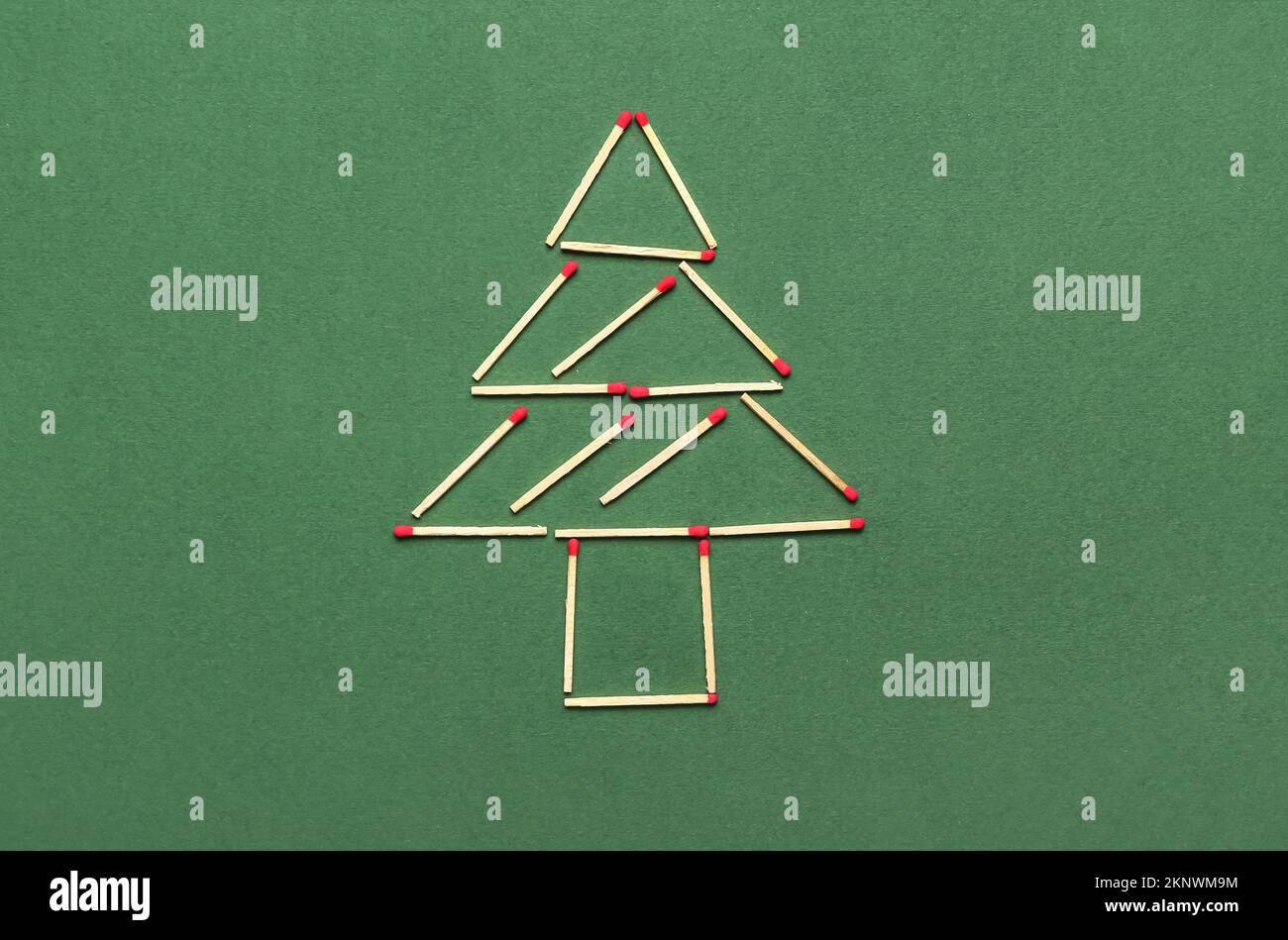 Christmas tree made of matches on green background Stock Photo Alamy