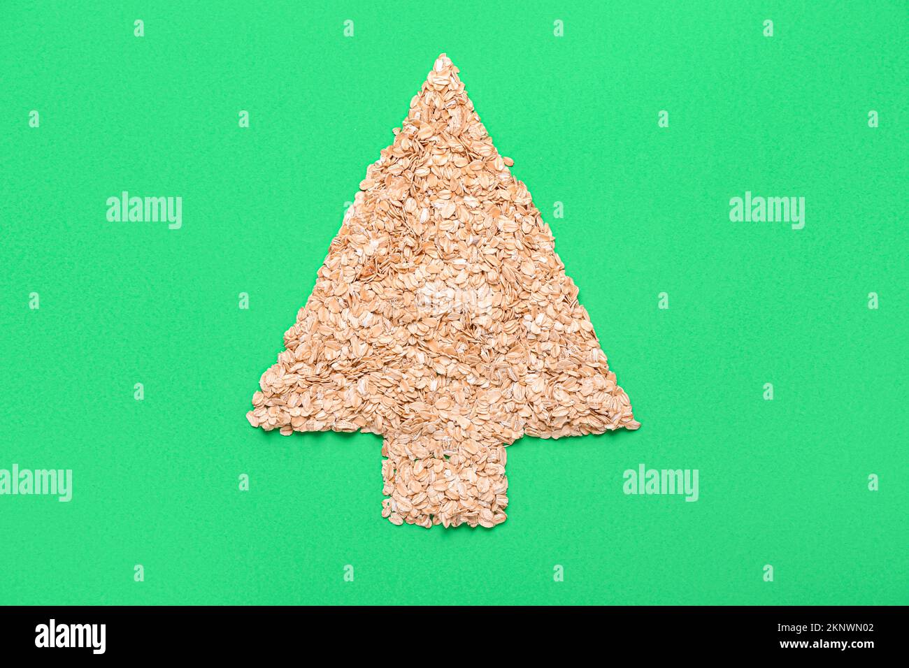 Christmas tree made of oat flakes on green background Stock Photo Alamy