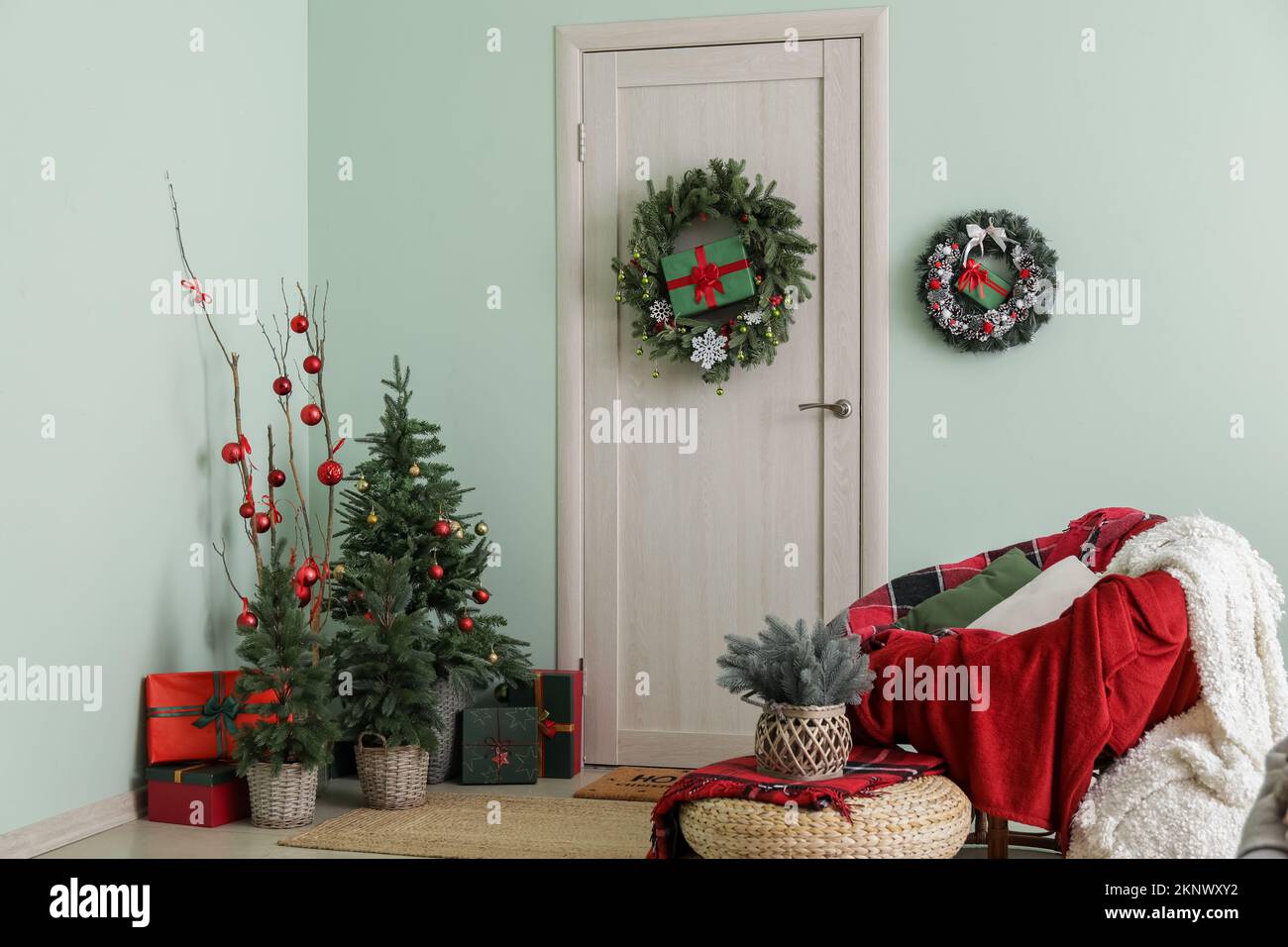 Interior of hall with wooden door, Christmas decor and armchair Stock ...