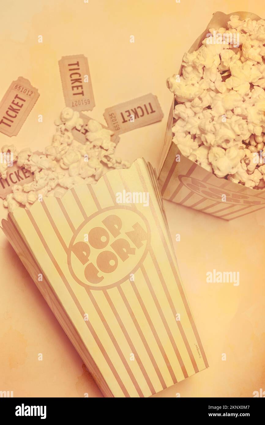 Old style retro popcorn containers fill with movie theatre stubs and buttered pop corn