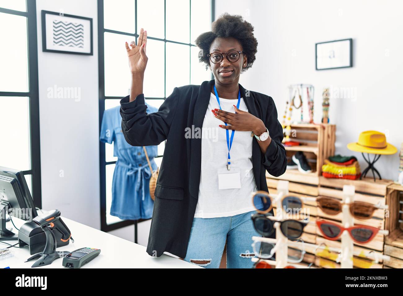 African young woman working as manager at retail boutique smiling ...