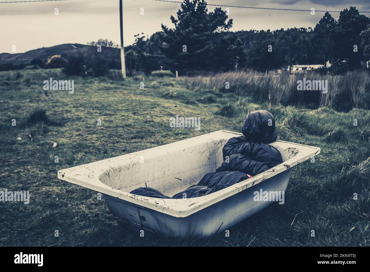 Scary dead body wrapped and tied up in plastic bag outside in old