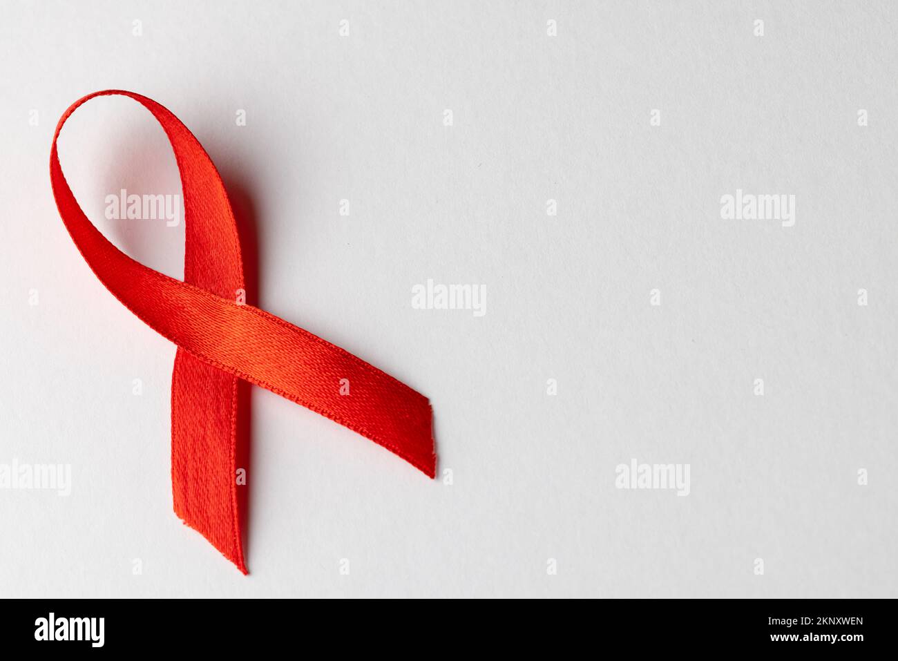 Composition of red ribbon for hiv or aids awareness, on white background with copy space Stock Photo