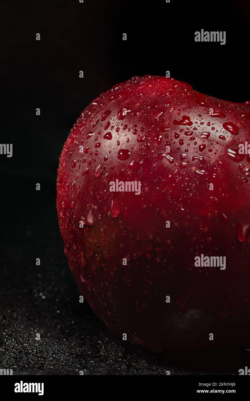 red apple with water drops on black background Stock Photo