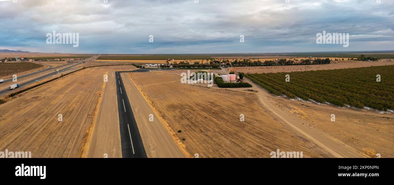 Landing strip next to Highway 5, Harris Ranch in distance.  Stock Photo