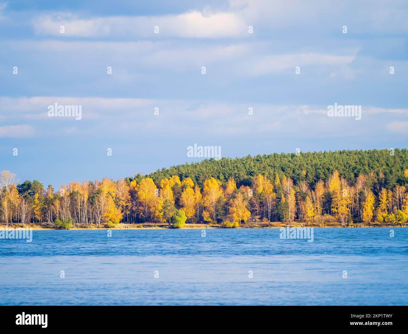 Autumn lake with yellow trees on the shores. Reflection of blue sky ...