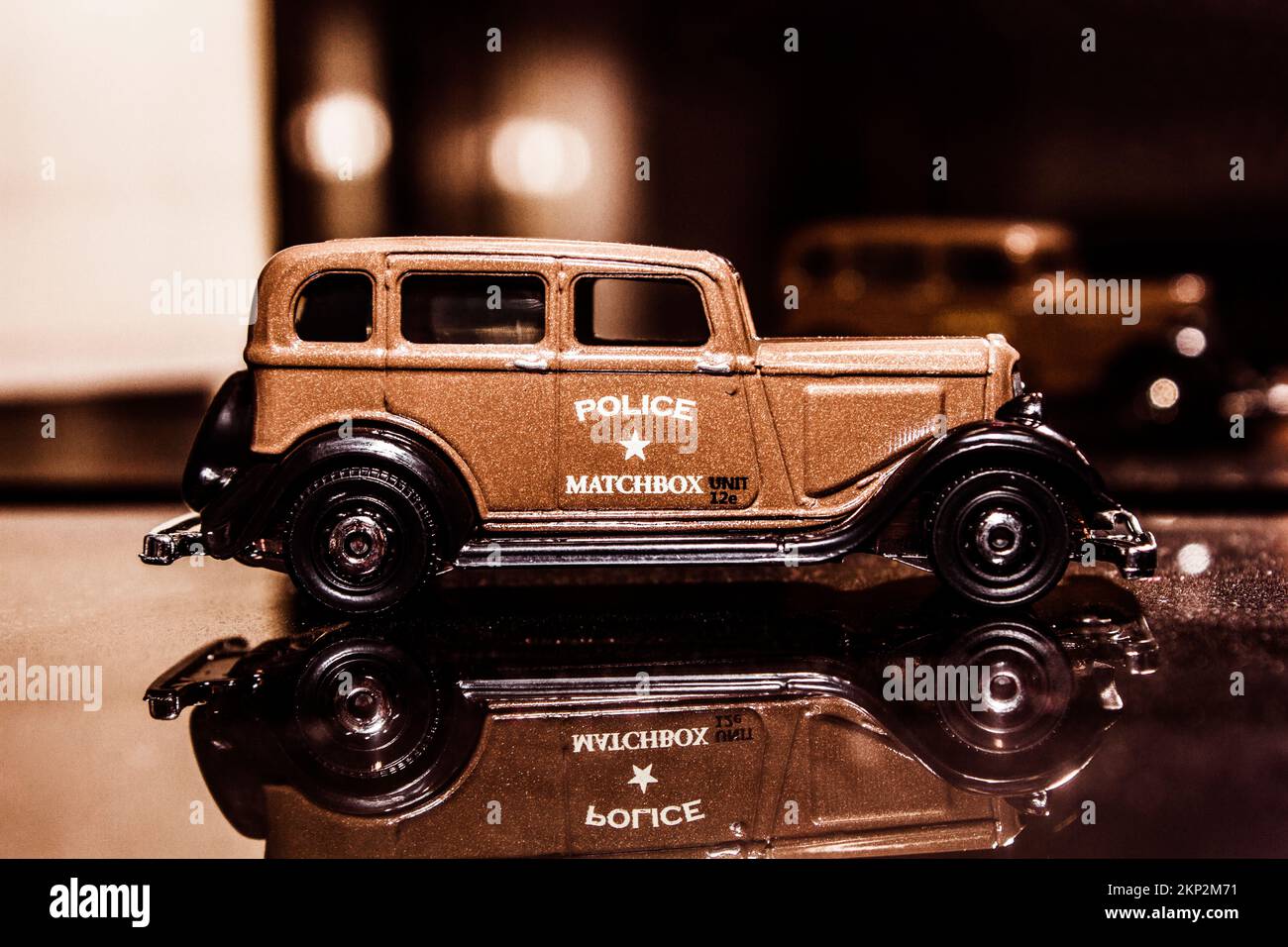 Historic model scene on a toy 1933 Plymouth police car from past force play. Matchbox Cops Stock Photo
