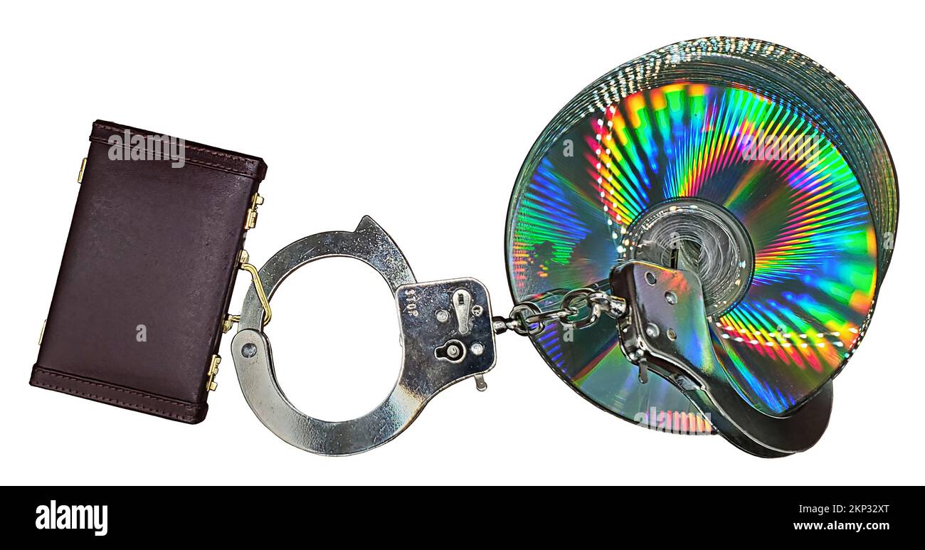 Leather briefcase handcuffs and DVDs showing stealing business data Stock Photo