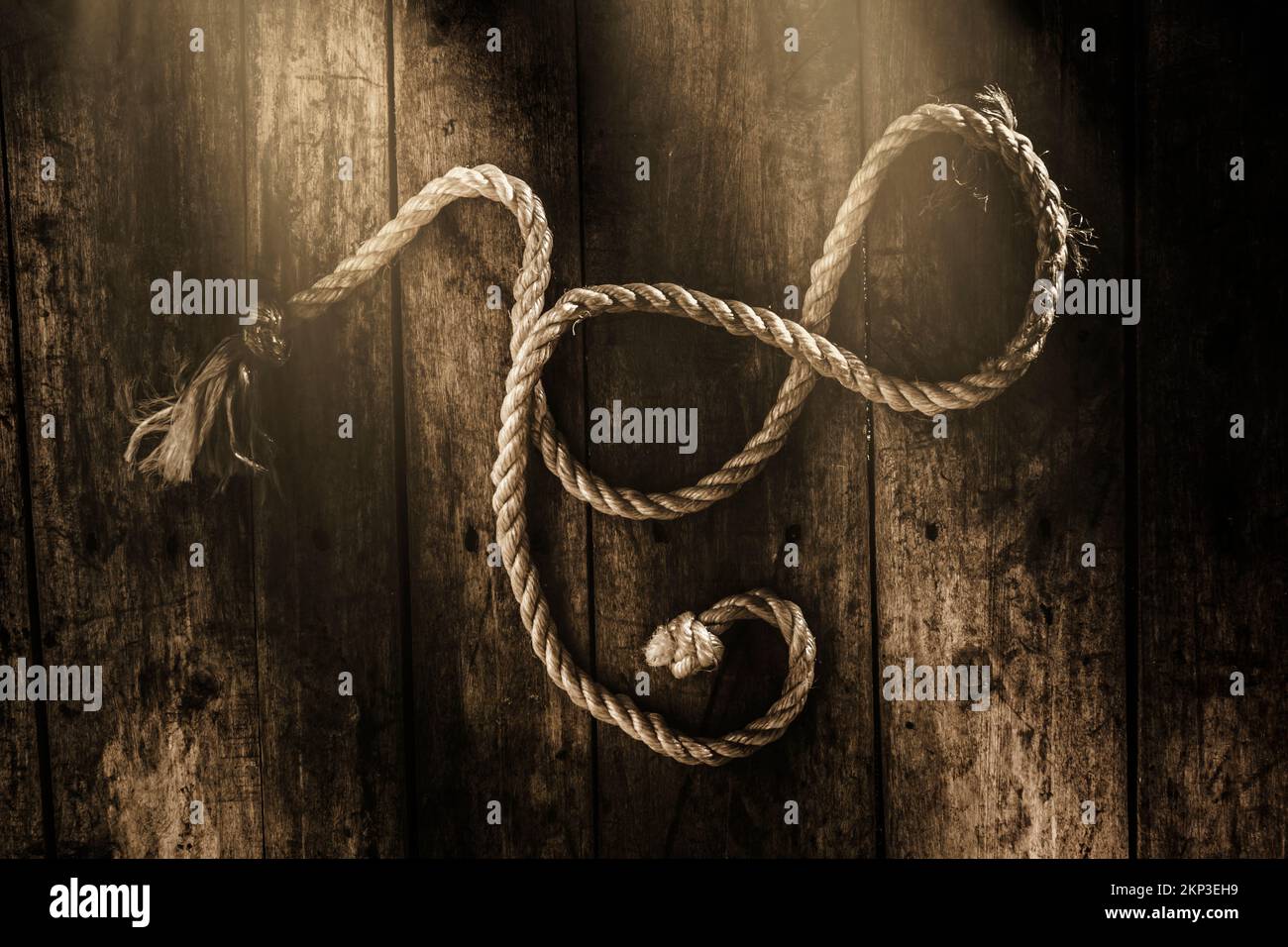 Shabby still-life art on a maritime rope twined into a symbol of sailing in perpetuity.  Forever a sailor Stock Photo