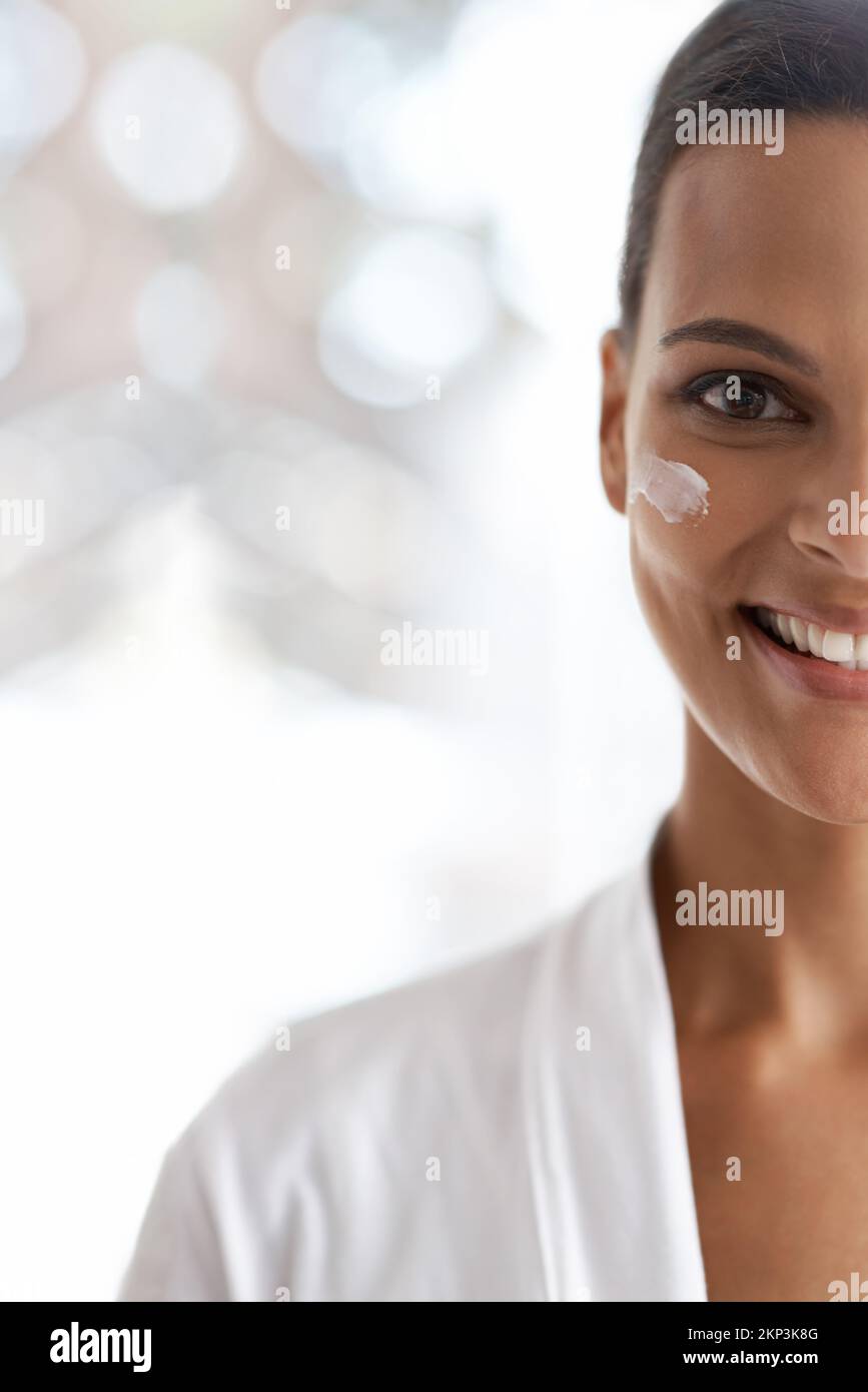 Fresh and light skin care options. Closeup portrait of a gorgeous young woman applying moisturizer to her skin. Stock Photo
