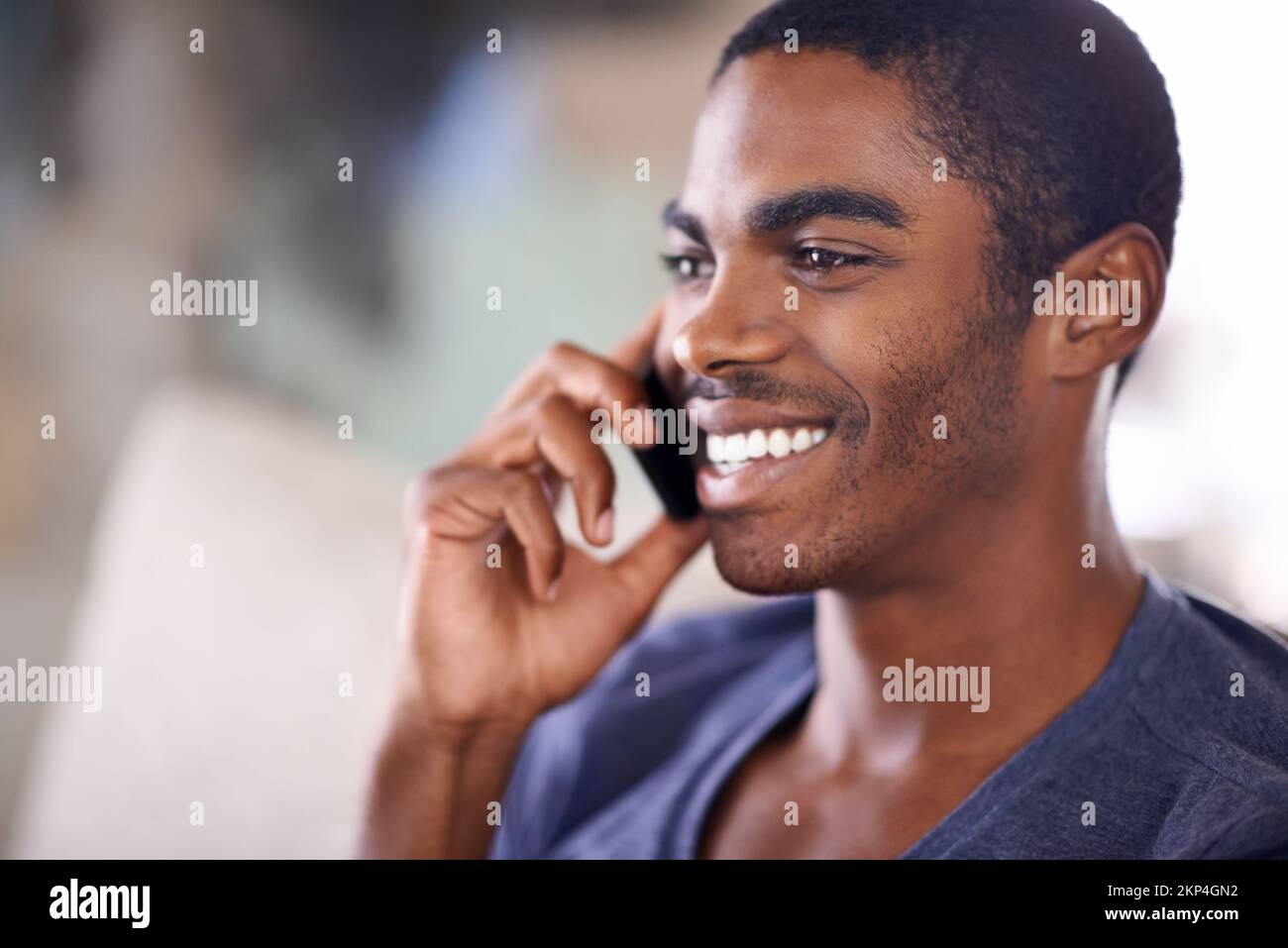 Checking up on that special someone. a handsome young man using his cellphone while chilling at home. Stock Photo