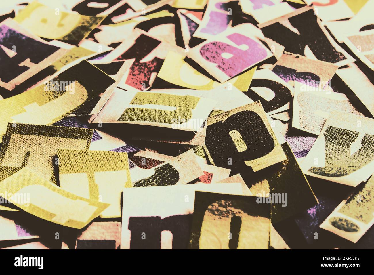 Retro still-life photo on a scattered crossword of chopped newspaper print. Abstract typescript Stock Photo