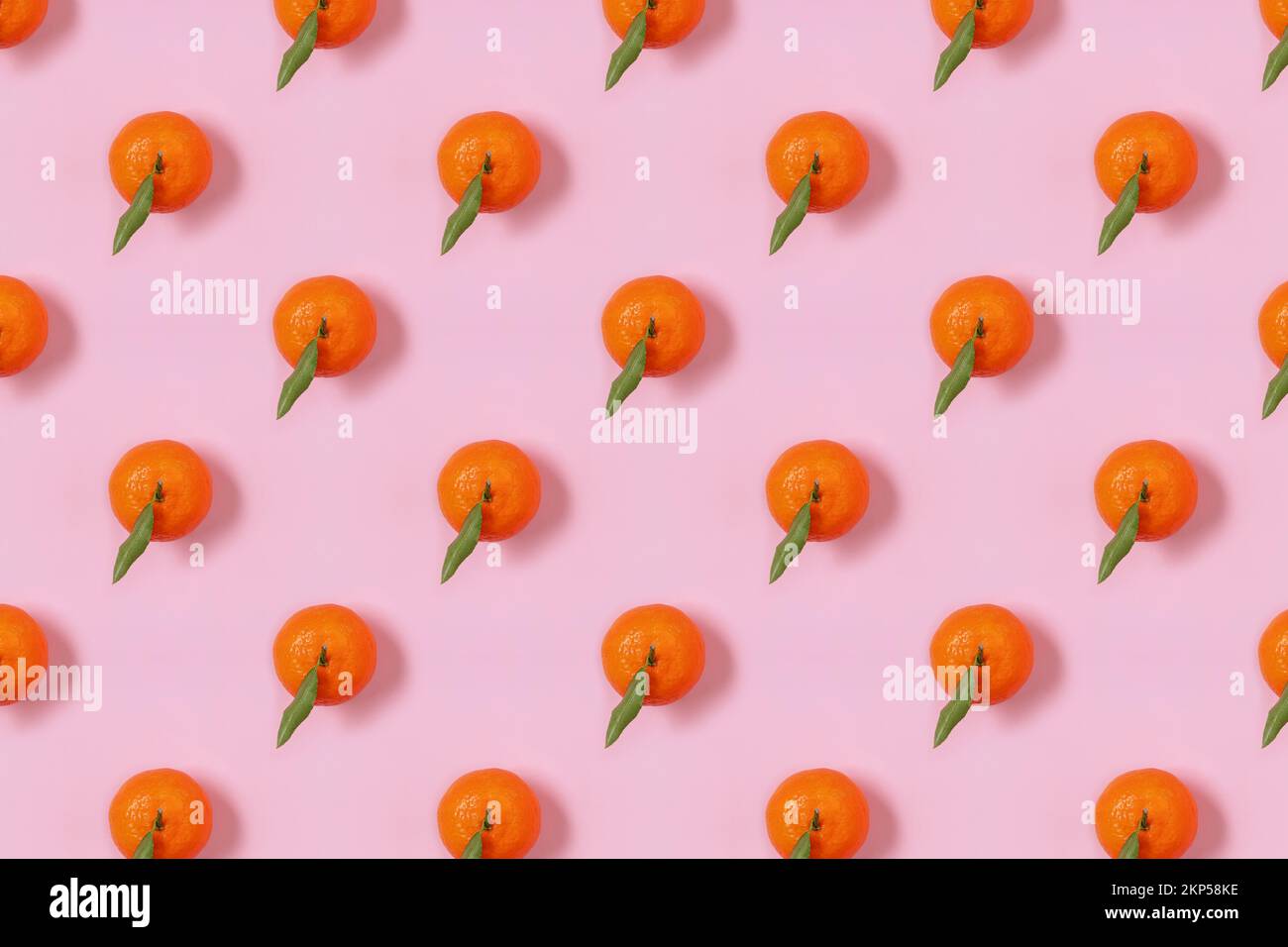 Mandarin oranges pattern on pink background. Creative pattern, fruit background. Stock Photo