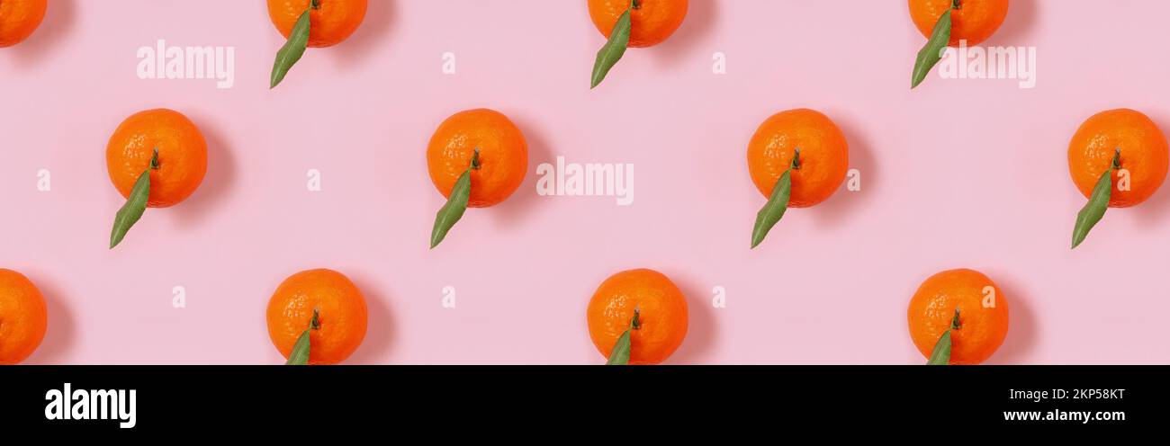 Banner with mandarin oranges pattern on pink background. Creative pattern Stock Photo