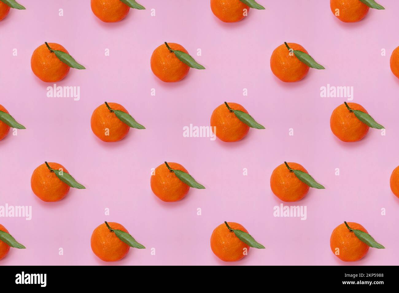 Mandarin oranges pattern on pink background. Creative pattern, fruit background. Stock Photo