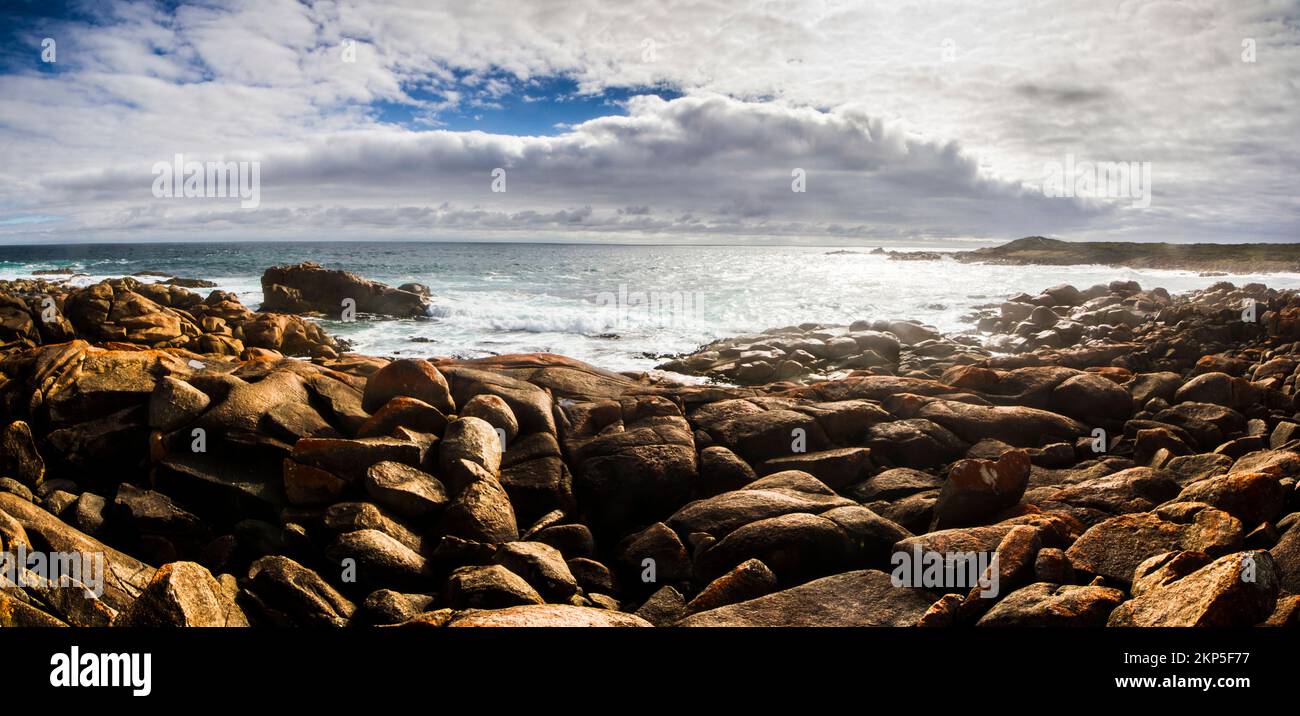 Oceanic panoramic background on a boulder covered Tasmania seaside in