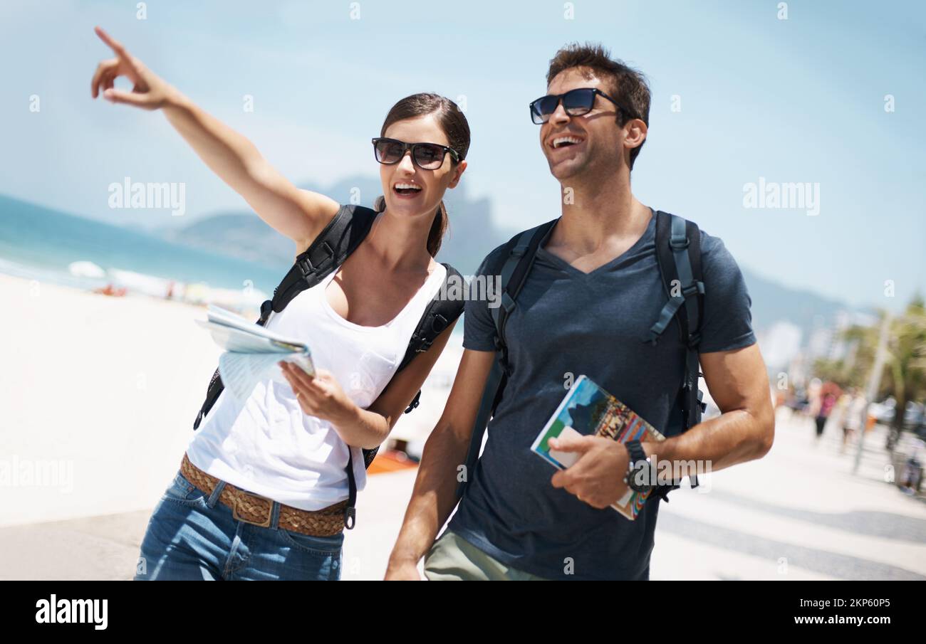 Seeing the sights in paradise. two young tourists at the beach. Stock Photo