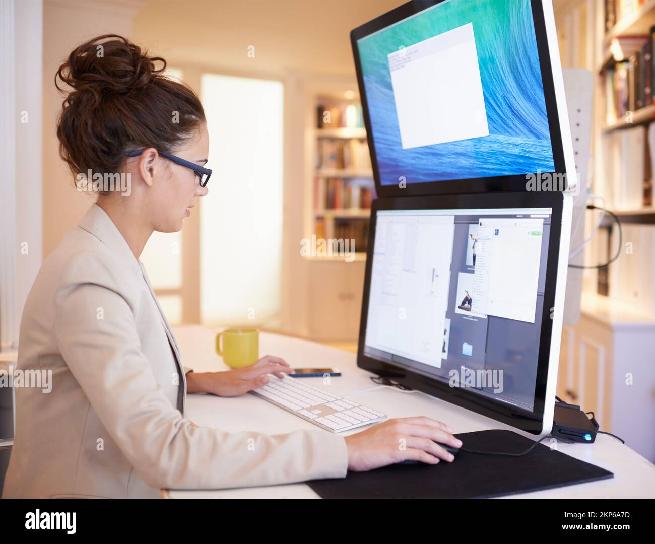 She knows how to optimize productivity. a young woman working on a dual ...