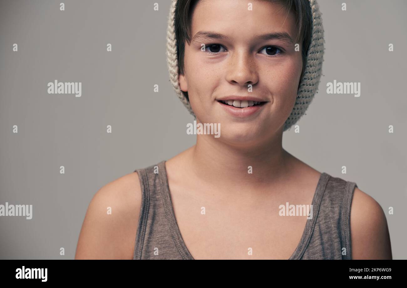 Young and hip. Studio portrait of a stylishly dressed young boy wearing a woolen hat. Stock Photo