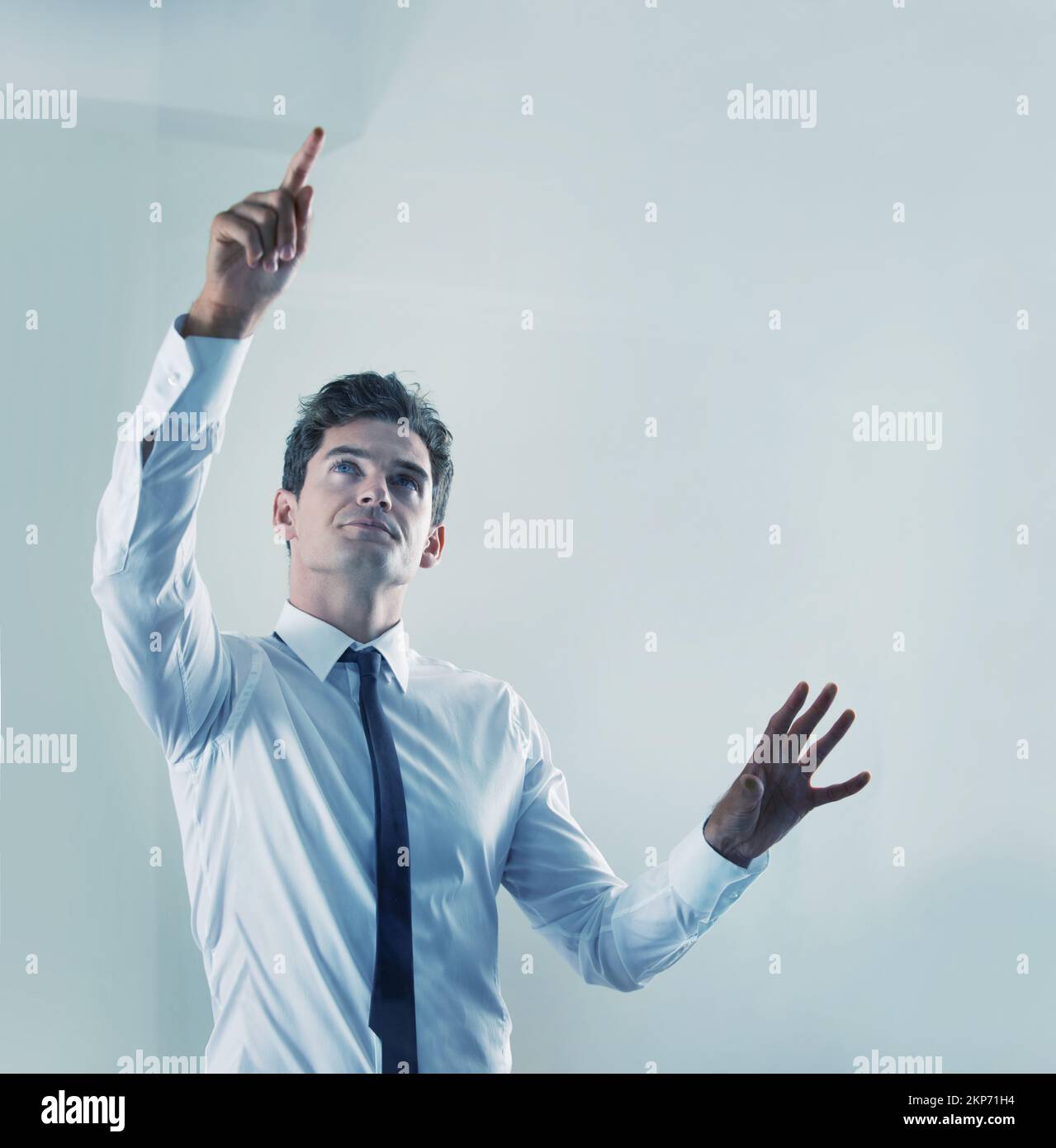 The future is now - Touchscreen technology. a young businessman using an unseen digital interface. Stock Photo