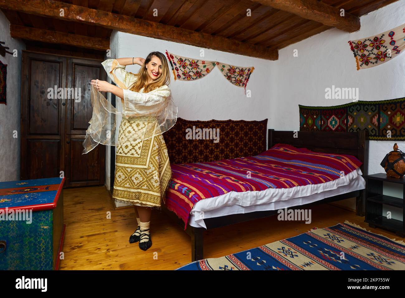 Young Romanian woman in traditional bride popular costume in a vintage home Stock Photo