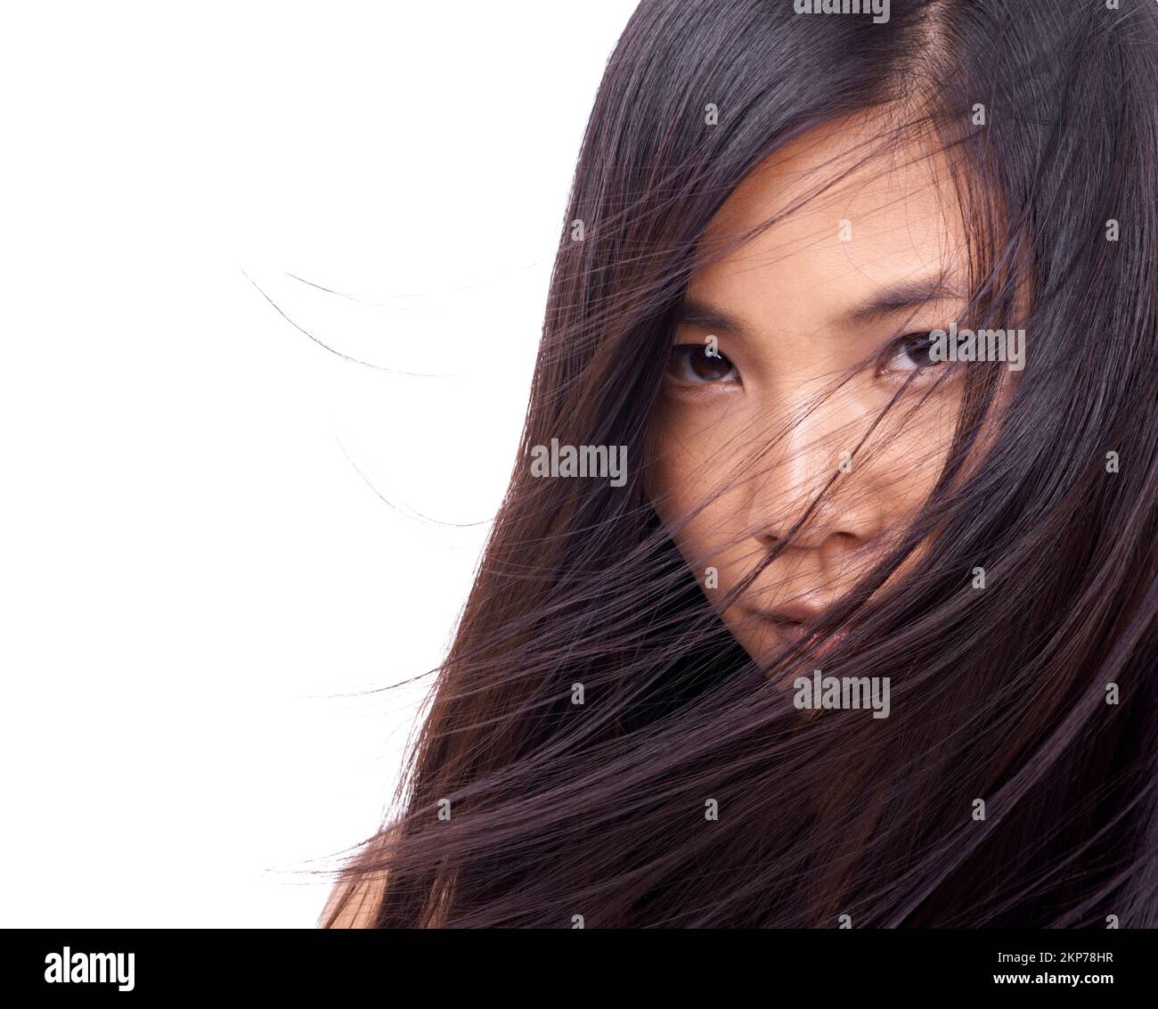 Why so coy. a beautiful young oriental woman against a white background. Stock Photo