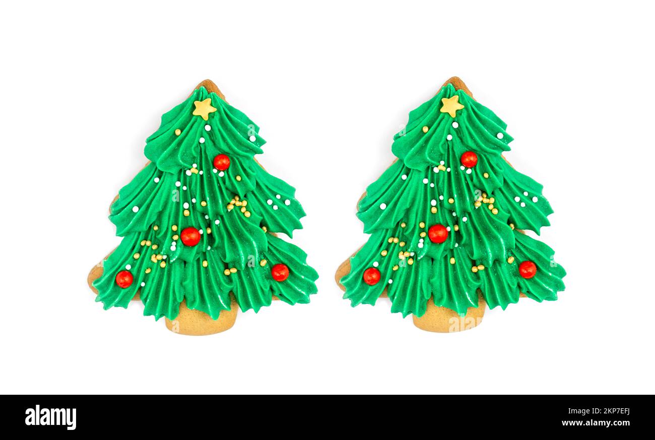 Two Christmas tree shaped cookies isolated on white background. Stock Photo