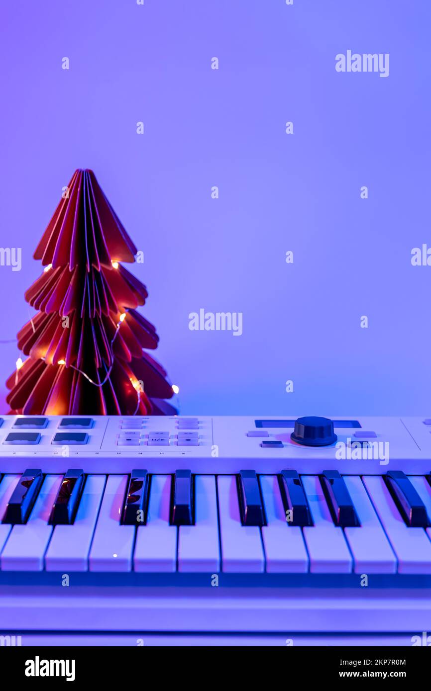 Christmas background with midi keyboard and holiday decor with neon