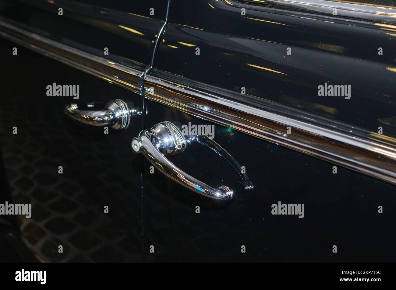 Chromed handles on the door of a black retro car Stock Photo - Alamy