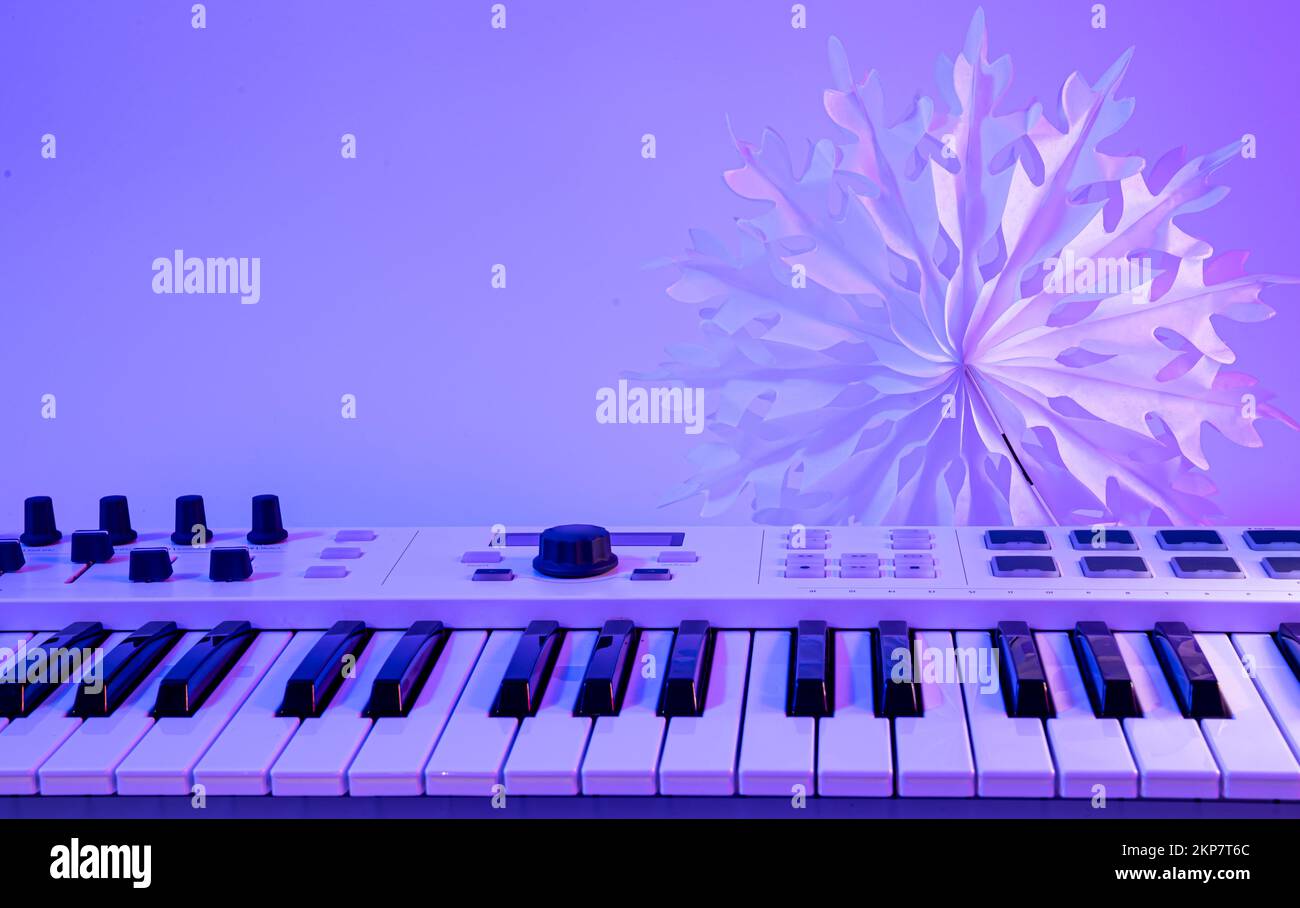 Christmas background with midi keyboard and holiday decor with neon