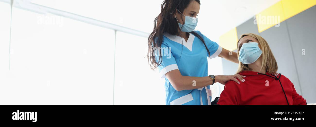 Medical worker visit patient in room, woman in wheelchair in rehabilitation center Stock Photo
