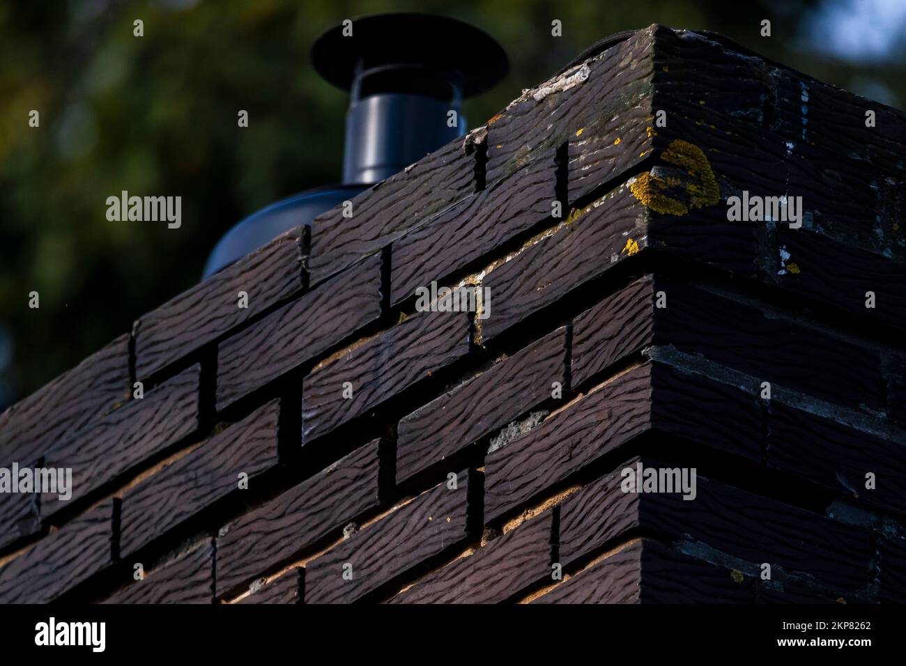 The partial view of a brick wall with a wooden design Stock Photo