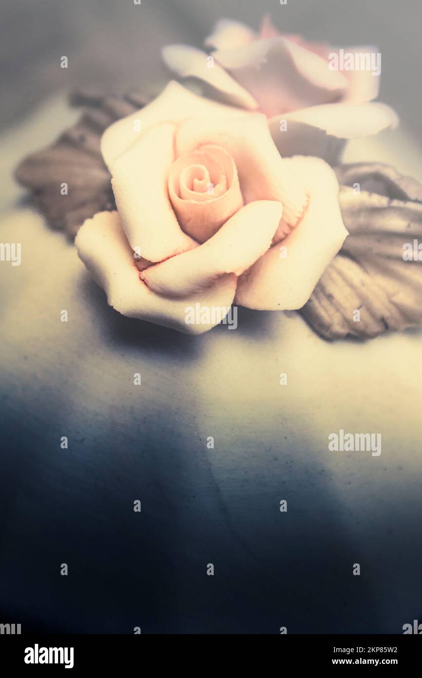 Creamy white rose flower made out of porcelain with bronze petals