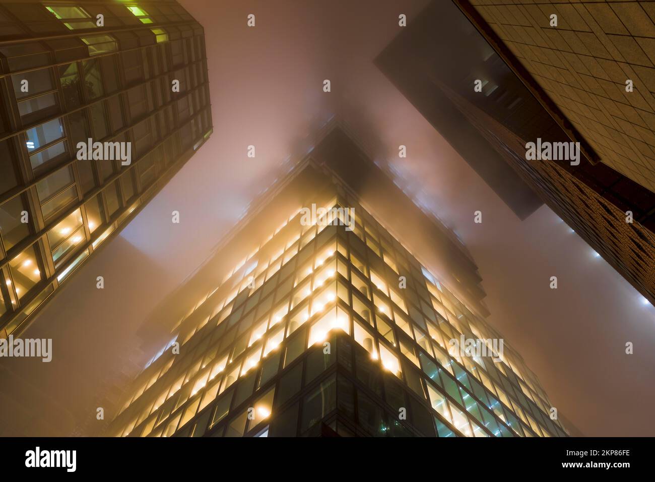Illuminated skyscrapers in the fog at night, Omniturm in the middle, Japan Center on the right, Garden Tower on the left, banking district, Frankfurt Stock Photo