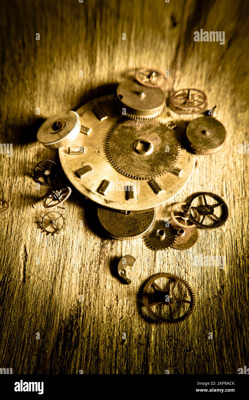Rustic art on clockwork equipment on wooden watchmakers desk