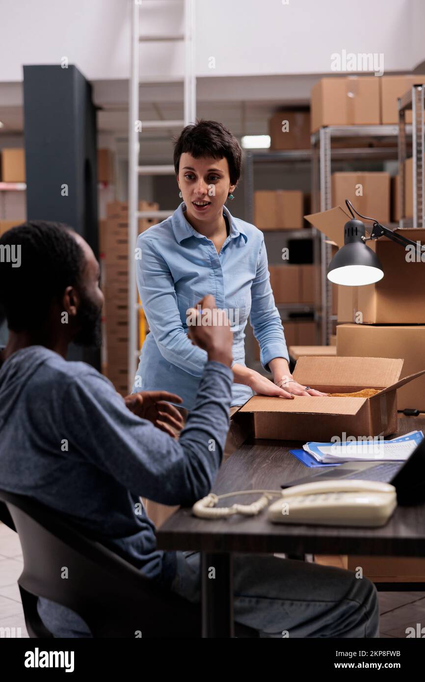 Supervisor and manager discussing transportation logistics while