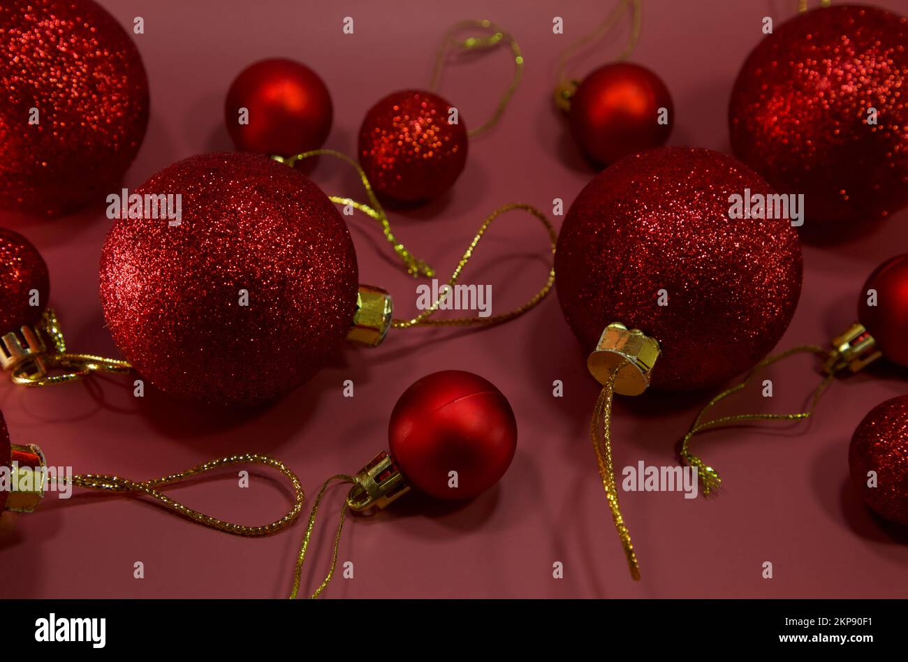Christmas red balls, baubles isolated on red background. Christmas decoration. Flat lay. copy space. top view. Stock Photo
